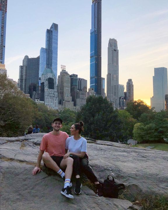 Hayden and Phoebe sitting on a rock in Central Park at sunset